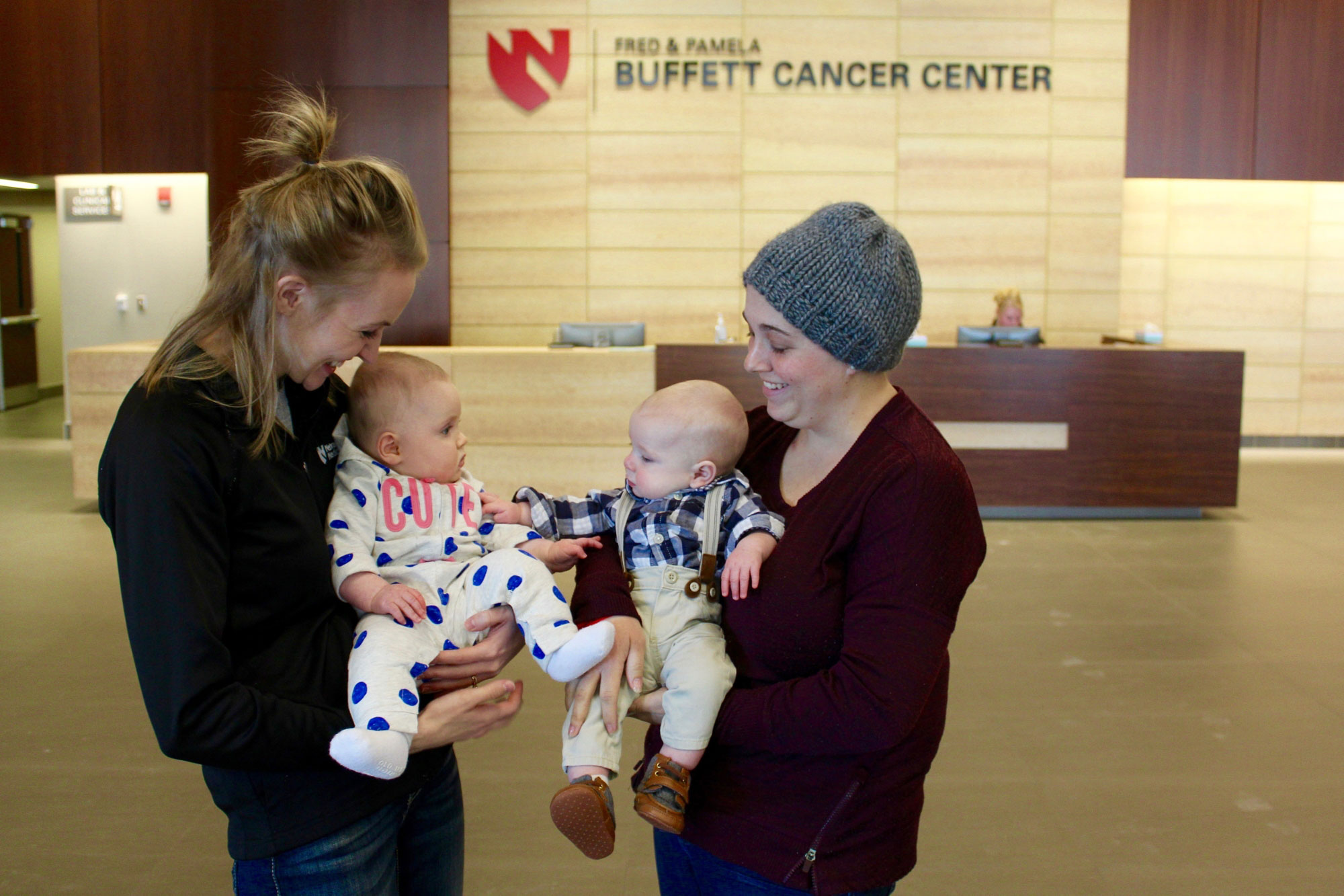 Jaclyn (’15) and Halle Kenney share a moment with Ashley and Easton Chestnut. Photo credit Nebraska Medicine