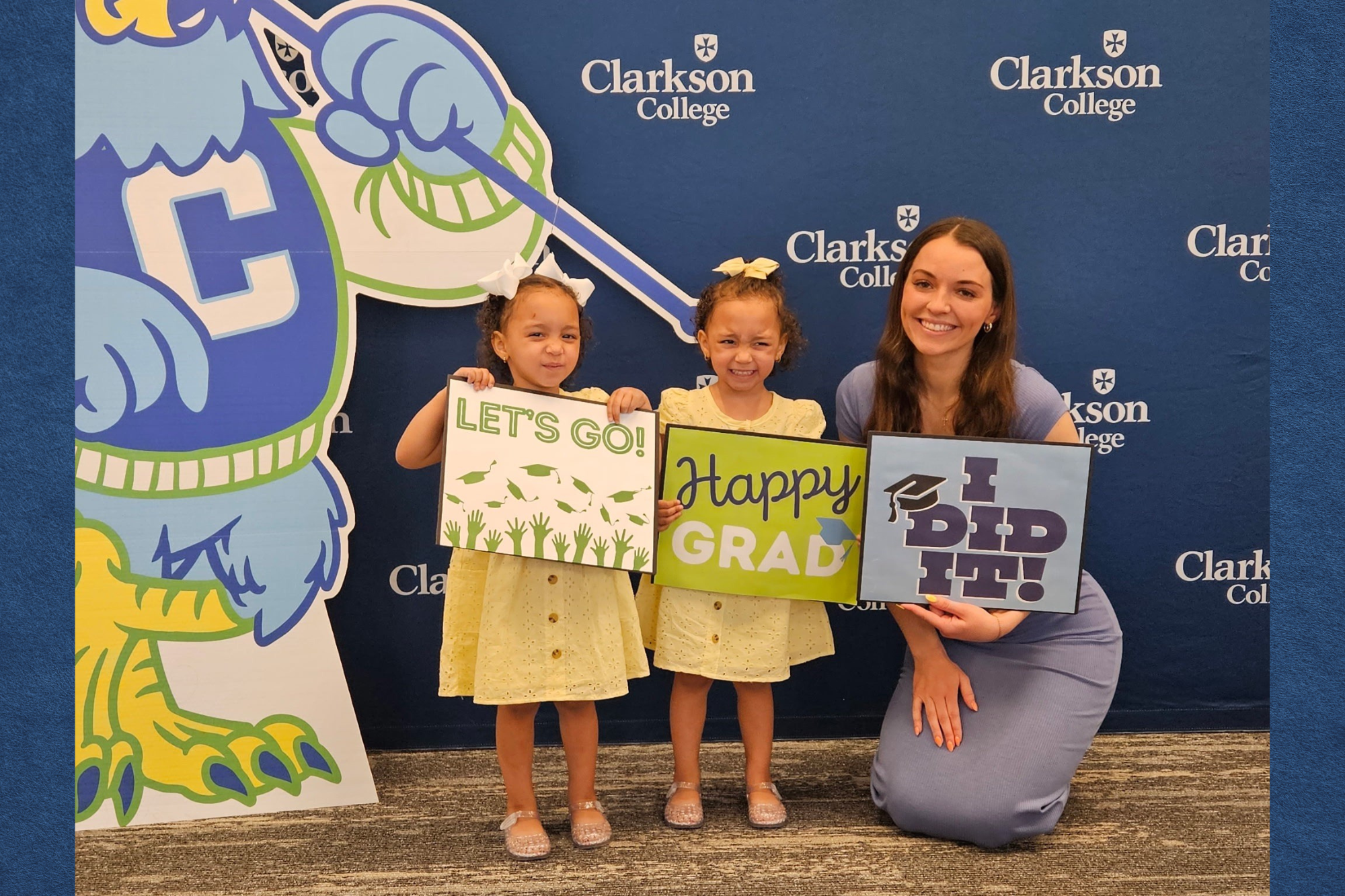Student Emily Thinnes at diploma pick up day with her young daughters