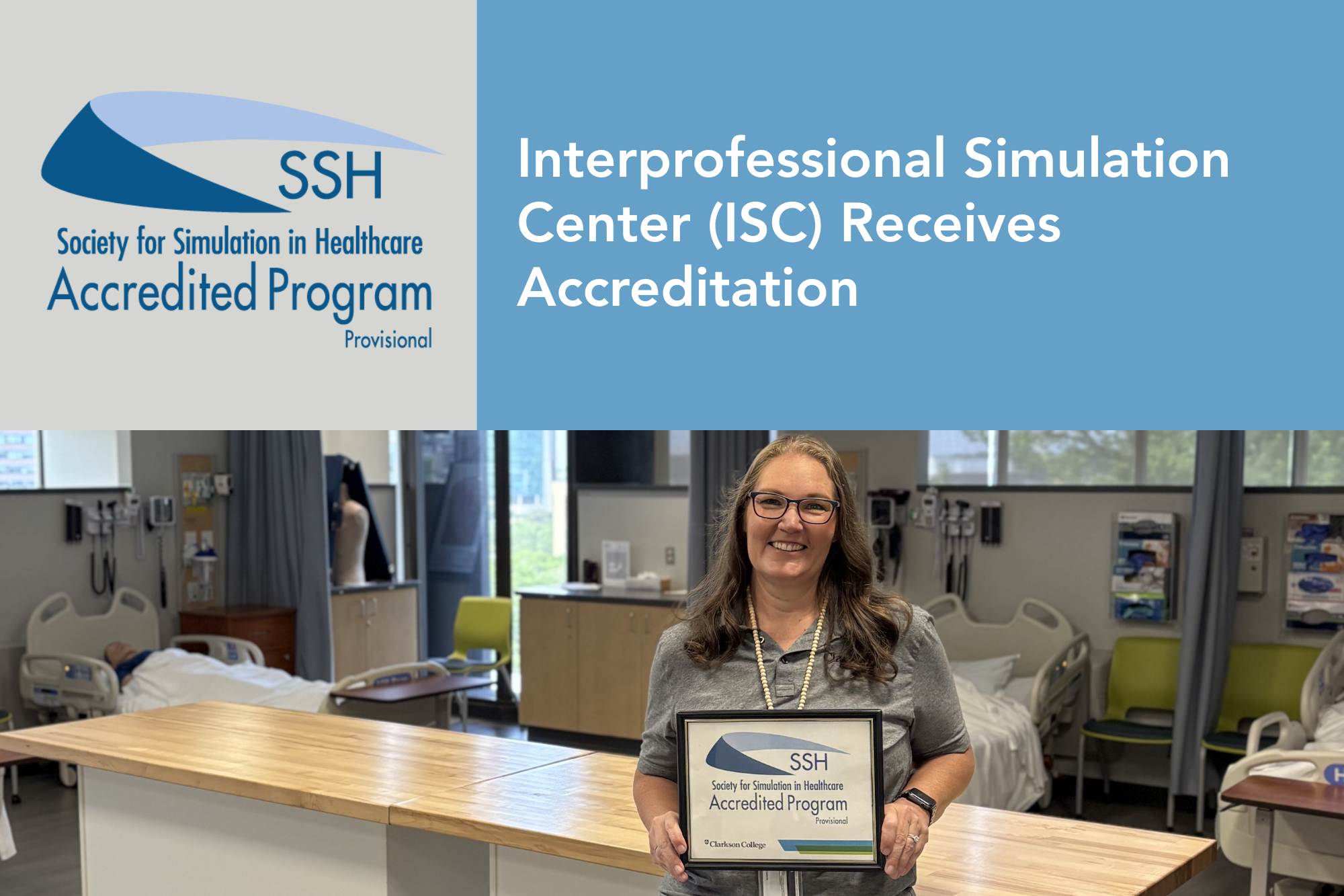 Sally Stimson holding her certificate of accreditation.