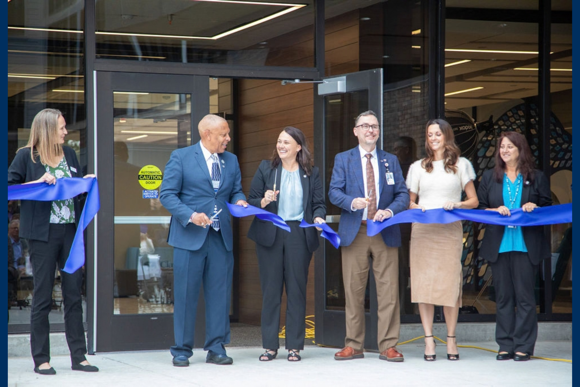 Celebrating a ribbon-cutting event on Sept. 21. 